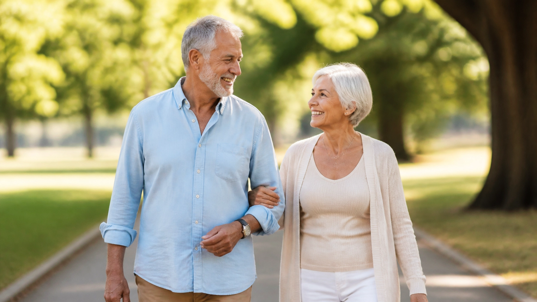 A senior couple walking together in a park, symbolizing healthy aging and preventive care